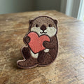 Otter Holding Heart Iron On Embroidered Patch — Iron-on patch
