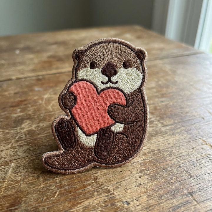 Otter Holding Heart Iron On Embroidered Patch — Iron-on patch